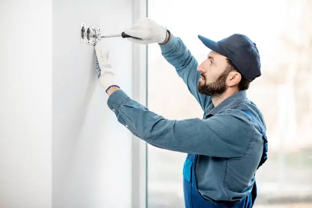 Photo of Electrician mounting sockets indoors