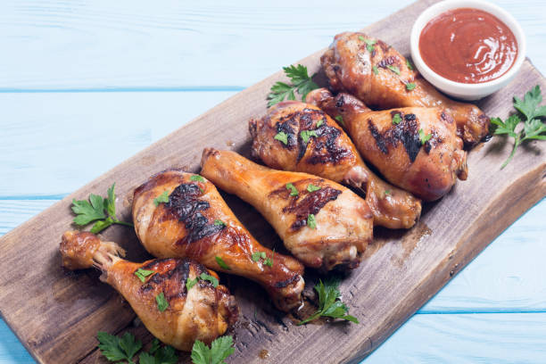 istock Grilled chicken legs with tomato sauce BBQ food background 1069571984