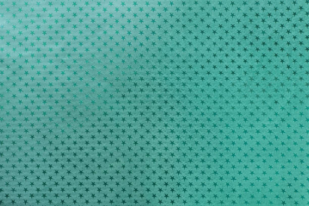 istock Dark turquoise background from metal foil paper with a stars pattern 1069572170