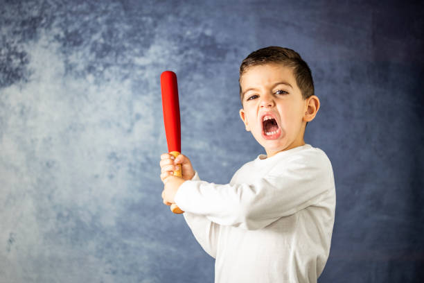 little kid screaming with a bat in his hands - baseball bat fotos imagens e fotografias de stock