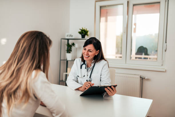istock Beautiful female specialist talking to her patient. 1069577170