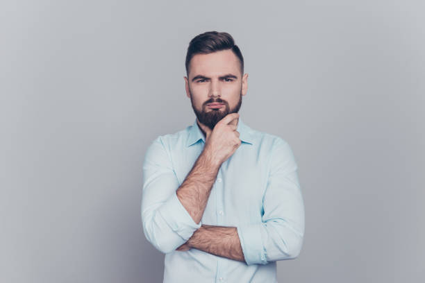 istock Let me think a bit! Close up studio photo portrait of handsome grimacing looking at camera brutal strategic bookkeeper calculating find new solution for problem task isolated grey background 1069578236
