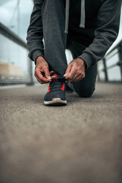 istock Senior athlete tying shoelaces. 1069580002