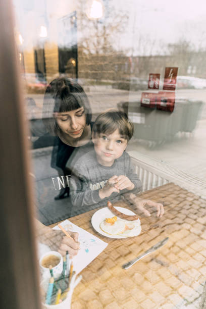 istock Mother with son eating in cafe 1069582602