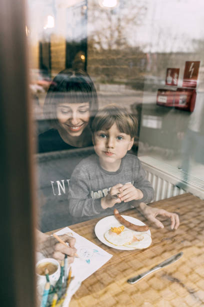 istock Mother with son eating in cafe 1069582606