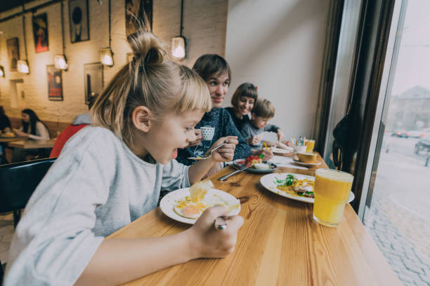 istock Family with two children eating in cafe 1069582650