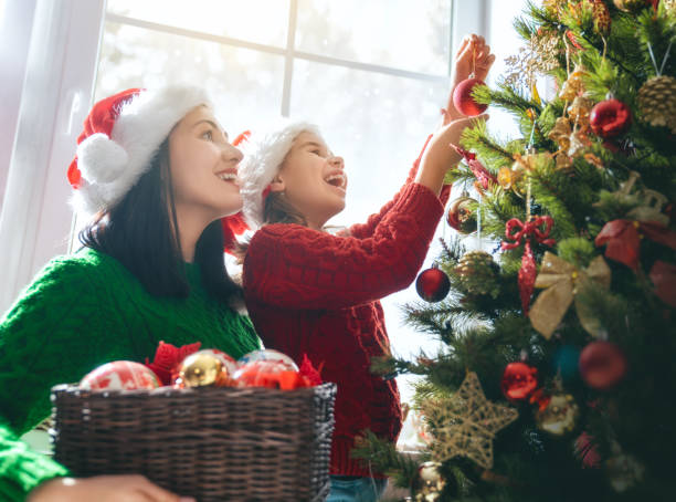 istock Mom and daughter decorate the Christmas tree 1069582844