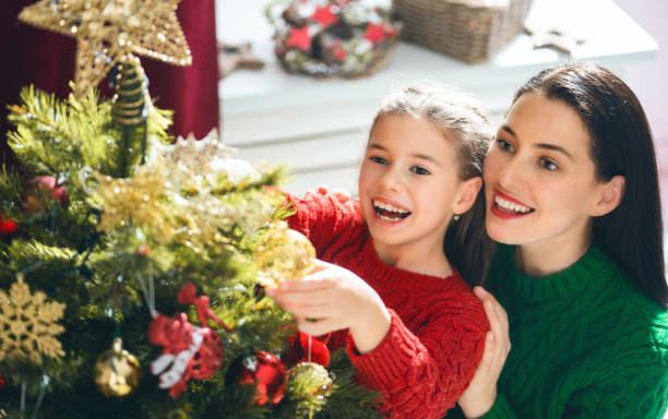 istock Mom and daughter decorate the Christmas tree 1069582896