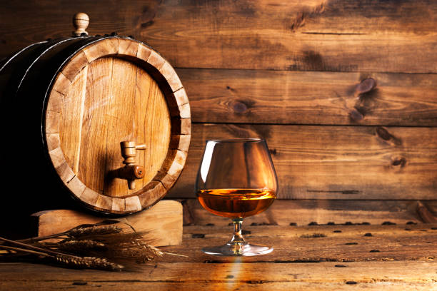Brendy glass and old oak barrel Brendy glass and old oak barrel cognac brandy photos stock pictures, royalty-free photos & images