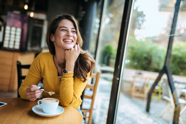 istock Happy woman drinking coffee at the cafe. 1069585088