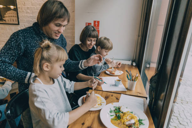 istock Family with two children eating in cafe 1069586524