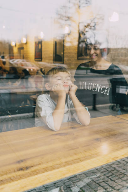 istock Mother with daughter sitting in cafe 1069586558