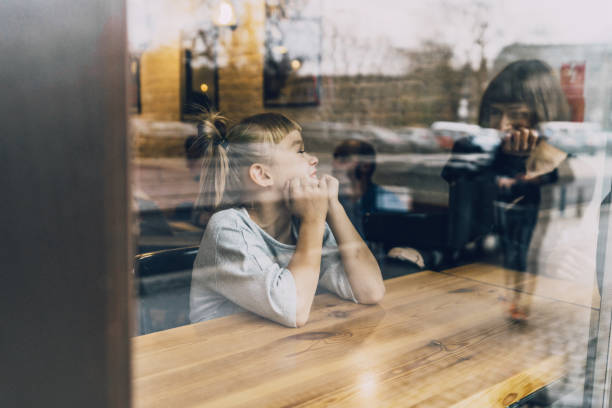 istock Mother with daughter sitting in cafe 1069586568
