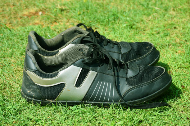 istock Sport shoes on grass background 1069587996