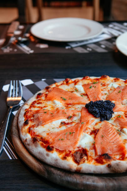 istock Smoked Salmon thin crispy italian pizza with black Caviar 1069589406