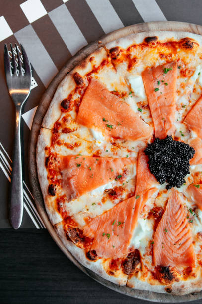 istock Smoked Salmon thin crispy italian pizza with black Caviar 1069589414