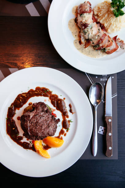 istock Beef Filet mignon steak with red wine gravy sauce and baked potatoes 1069589424