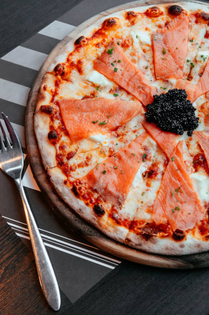 istock Smoked Salmon thin crispy italian pizza with black Caviar 1069589444