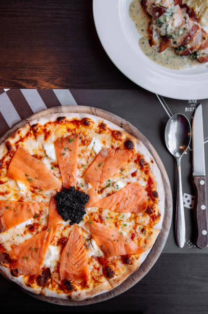 istock Smoked Salmon thin crispy italian pizza with black Caviar 1069589538