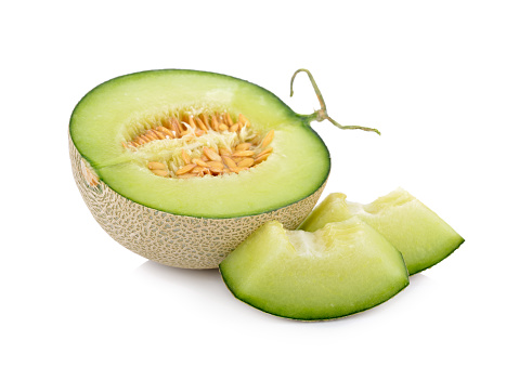 half and portion cut ripe sweet honeydew green melon on white background