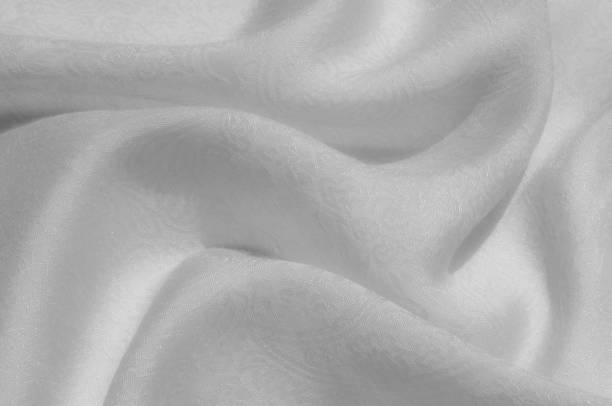 istock Texture, background, pattern. Fabric - silk light. Italian white fabric with white tones is a small floral pattern. Solid Silk Charmeuse fabric - light silver lining 1069592184