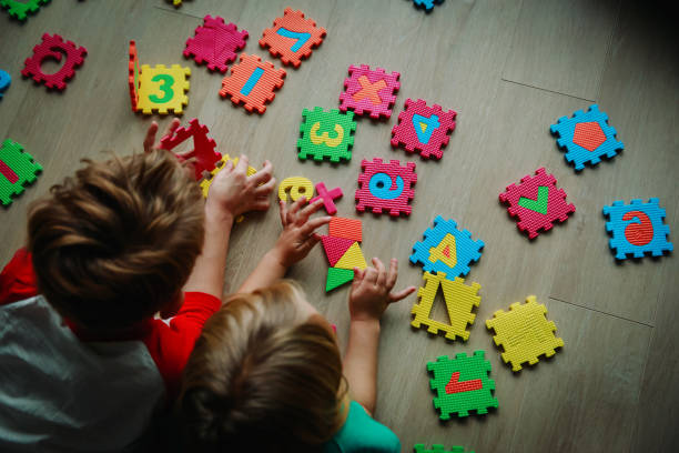 istock kids playing with number puzzle, education concept 1069593850