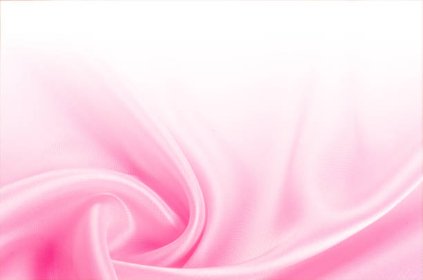 istock Texture, background, pattern. Light beige, pink shades of silk fabric, text space. Pink silk background based on natural texture 1069593878