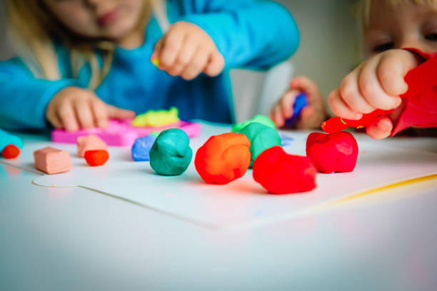 kids play with clay molding shapes, learning through play - modeling clay imagens e fotografias de stock