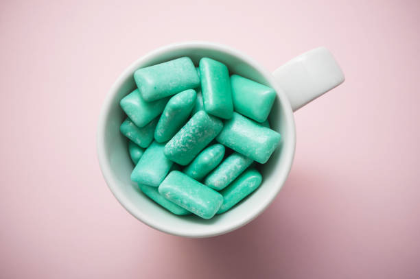 istock peppermint chewing gum in a white cup on pink background 1069594656