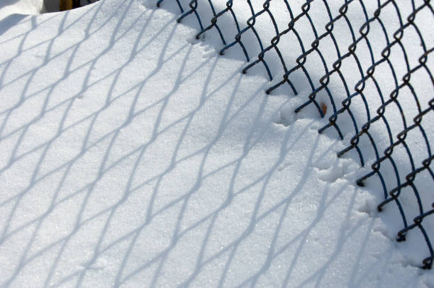 istock Winter landscape. texture background. reflection of shadows on the snow from the artificial fence 1069594782