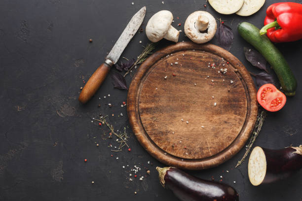 istock Wooden desk with vegetables on brown background 1069595060