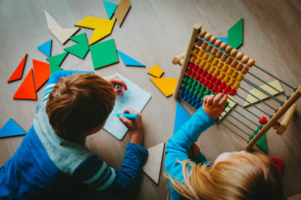 istock little boy and girl learn to write and calculate numbers 1069595448