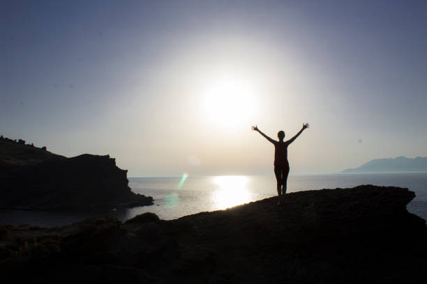 istock Woman enjoying at sunset 1069595700