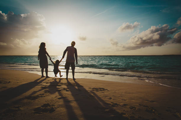 istock happy family with two kids on play on sunset beach 1069596942