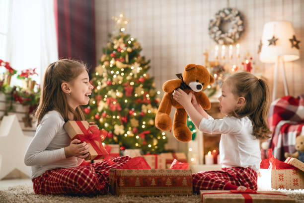 istock girls opening Christmas gifts 1069600862