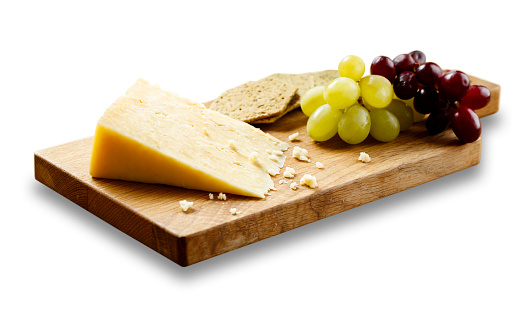 Isolated image of Cheese, crackers and grapes on wooden board.