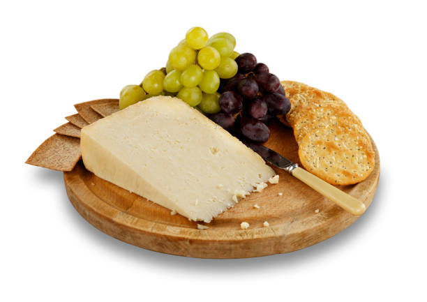 istock Cheese, crackers and grapes on wooden board. 1069600938