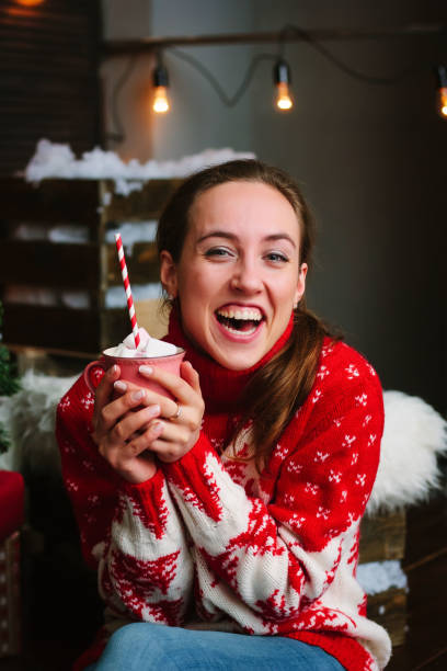 istock Beautiful girl laughing with christmas marshmallow in hands. 1069602602