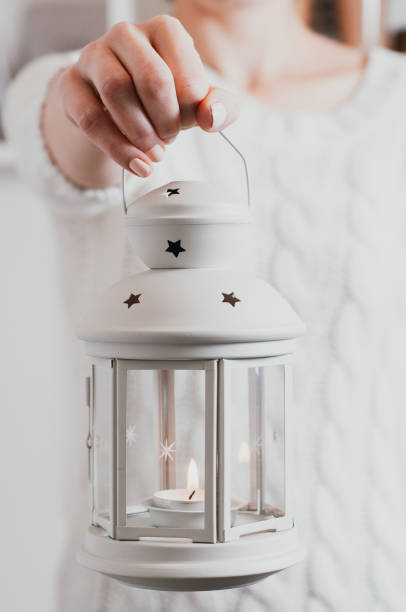 istock A woman in a white sweater holding a Christmas lantern 1069603720
