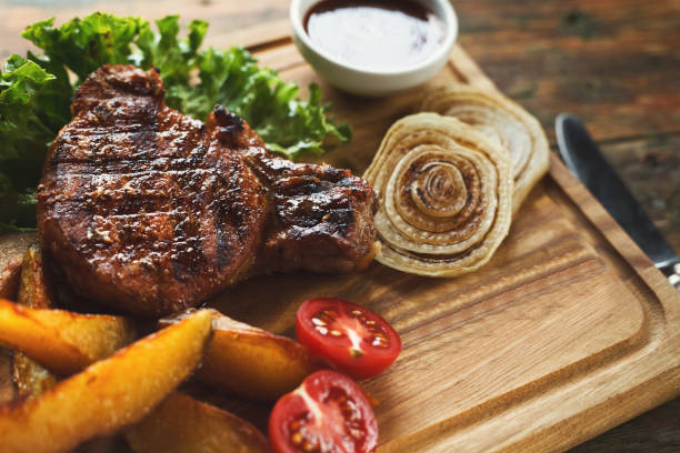 istock Grilled pork steak with potato wedges closeup 1069606022