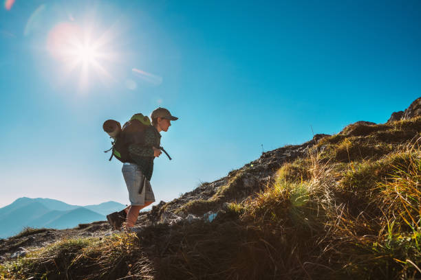 istock Little Boy backpacker traveler walk up on mountain top 1069606658