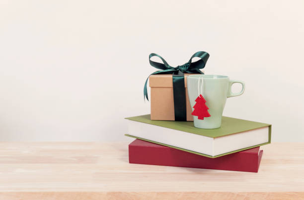 istock Christmas present and cup on wood table with copy space for design. 1069624298