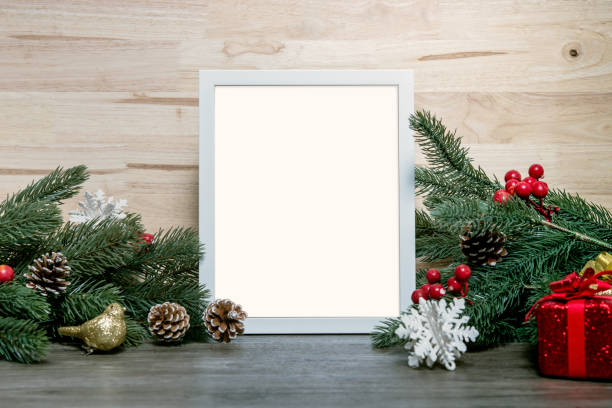 istock Christmas holiday greeting frame design mockup with decoration on wood table. 1069624402