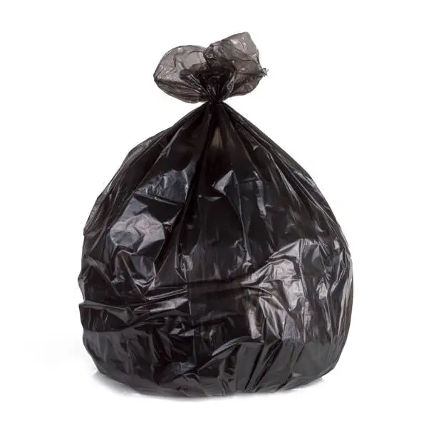 Photo of close up of one black garbage bag isolated white background with