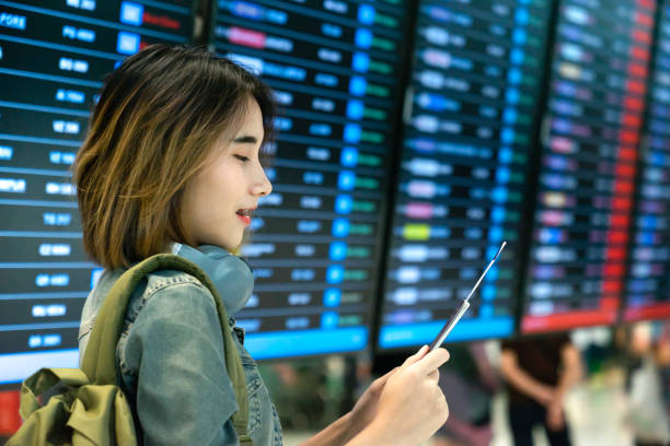 Asian girl check your passport before boarding at the international airport stock photo