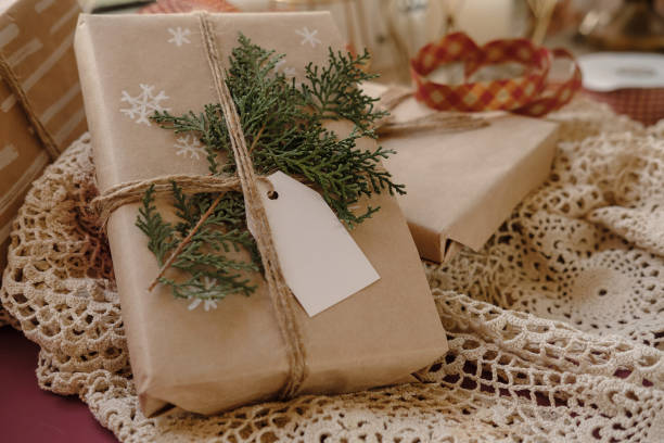 istock Blank Gift tag on Classy vintage Christmas gift box on lace tablecloth background. Christmas presents with handmade decoration. Close up. Mockup. Copy space. 1069636826