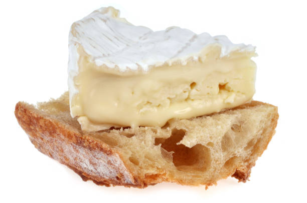 Camembert on bread on a white background