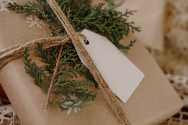 istock Blank Gift tag on Classy vintage Christmas gift box. Christmas presents with handmade decoration. Close up. Mockup. Copy space. 1069636970