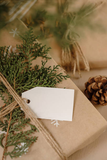 istock Blank Gift tag on Classy vintage Christmas gift box. Christmas presents with handmade decoration. Close up. Mockup. Copy space. 1069637100