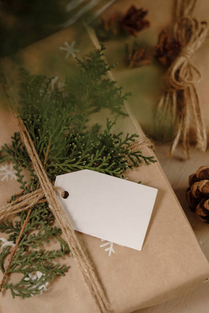 istock Blank Gift tag on Classy vintage Christmas gift box. Christmas presents with handmade decoration. Close up. Mockup. Copy space. 1069637142